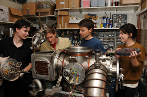 Graduate student Vincent Lonij (left), associate professor of physics Alex Cronin, research assistant Will Holmgren and undergraduate student Catherine Klauss perform maintenance on a chamber used to beam atoms through a grating to measure a tiny force that helps physicists better understand the structure of atoms. (Photo by Norma Jean Gargasz/UANews) Graduate student Vincent Lonij (left), associate professor of physics Alex Cronin, research assistant Will Holmgren and undergraduate student Catherine Klauss perform maintenance on a chamber used to beam atoms through a grating to measure a tiny force that helps physicists better understand the structure of atoms. (Photo by Norma Jean Gargasz/UANews)